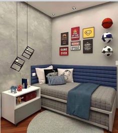 a room with a couch, bed and basketballs on the wall above it is decorated in gray and blue