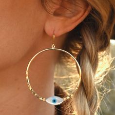 These gorgeous hoops are the perfect earrings to wear with a simple tee, dress up with a black dress or rock on a zoom call. The Mother of Pearl evil eye shimmers in the light with its pearl essence. Let these earrings be your reminder to always protect your peace, just as an evil eye protects. 2" gold plated hoops Mother of Pearl evil eye Weight: 1/8 oz Handmade in Arizona Cheap Evil Eye Drop Earrings, Peace Earrings, Protect Your Peace, Meaningful Jewelry, Simple Tees, Zoom Call, Hammered Gold, Rock On, Mala Necklace