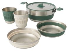 an assortment of dishes and cups on a white background with green trim around the lids