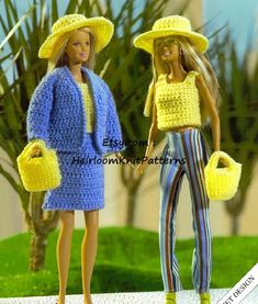 two barbie dolls dressed in crocheted clothes and hats, one holding a yellow purse