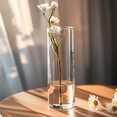 a glass vase filled with water and white flowers