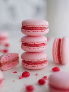 pink macaroons are stacked on top of each other