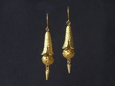 The design for these articulated earrings was taken from a pair found on an antiques website. The originals cost over £800! Long four petalled bell flowers with a hammered texture are suspended above ornate round beads. The design is terminated with a spike shaped dangle. All three parts are matte gold plated. They have handmade gold plated ear wires. Limited edition design. Handmade gold plated ear wires. Length (from top of ear wire to bottom of earring) 6cm (2.36 inches). Please note: All photos are taken under natural light. However different computer screens, operating systems, and even different web browsers have different colour characteristics, so it's just about impossible to get a given colour to look the same on every screen. If you have any questions please contact me. For more Articulated Earrings, Bell Flowers, Edwardian Era, Handmade Gold, Matte Gold, Victorian Fashion, Ear Wires, Handmade Earrings, Round Beads