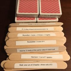 several wooden playing cards stacked on top of each other with numbers and words in them