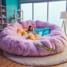 a woman is laying in a large purple bean bag chair with fluffy fur on it