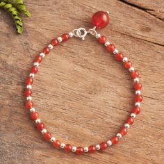 Gleaming with a natural magic orbs of red-orange carnelian alternate with shiny sterling silver beads as they circle the wrist. Peruvian artisan Adriana de Gadea creates this fascinating bracelet accented at the clasp with a carnelian charm that dangles. Carnelian Beaded Bracelets With Natural Stones As Gift, Amber Carnelian Beaded Bracelets - Gift, Amber Carnelian Beaded Bracelet Gift, Red Carnelian Beaded Bracelet With Round Beads, Red Carnelian Beaded Bracelets With Round Beads, Red Carnelian Round Beads Bracelet, Spiritual Carnelian Gemstone Bracelet, Hand-strung Carnelian Bracelets Gift, Hand-strung Carnelian Bracelet As Gift