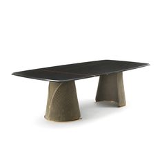 a black table with an oval shaped base and gold trimmings on the top