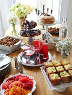 a wooden table topped with lots of food and drinks