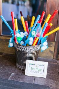 a cup full of toothbrushes sitting on top of a table next to a sign