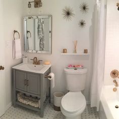 a bathroom with a sink, toilet and bathtub in it's center area