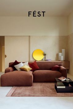 a living room filled with furniture and pillows