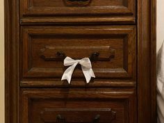 a drawer with a bow on top of it