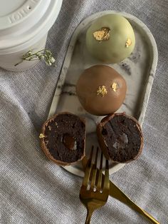 there are three desserts on the plate with forks