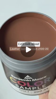 someone is holding up a cup of brown color to show the product in it's hand