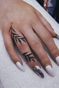 a woman's hand with a tattoo on it