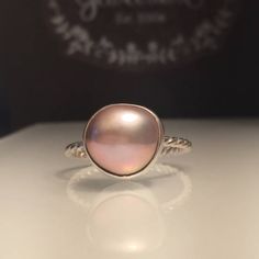 Blush Pearl ring.Pink Pearl Ring. Solitare Pearl Ring. Baroque Pearl Ring. Girlfriend Gift. Beautifully Handcrafted upcycled natural blush pearl set on a lightly Twisted solid silver band.. This unique yet very versatile ring is a size 9 but is available in any size and is sure to be your go to accessory for all your fresh spring looks. ❤️Give the thoughtful gift of handcrafted❤️ Great bridesmaid gift. (Will discount for higher quantities) just message me. All rings are handmade by me so feel... Elegant Pink Sterling Silver Stackable Rings, Fine Jewelry Pink Cabochon Ring, Adjustable Pink Round Moonstone Ring, Pink Round Moonstone Ring For Gift, Adjustable Pink Moonstone Round Ring, Adjustable Pink Moonstone Ring, Pink Moonstone Ring Gift, Rose Gold Pearl Ring With Gemstone, Rose Gold Round Pearl Ring