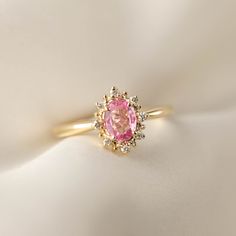 This is made to order ring. Beautiful unheated pink sapphire from Madagascar, weight ranges from 0.60 to 0.7ct, 7x5mm, eye clean 0.08ctw., G color SI clarity accent diamonds Band width: approx. 1.9mm High profile setting, easy stacking with a straight band Made of recycled solid 14k gold Our Dedication All our jewelry is designed and created by Kat with great attention to details and the entire production from casting, stone setting to finishing takes place in New York, USA. All gemstones used i Pink Ruby Halo Ring Perfect For Gift, Gift Pink Halo Ruby Ring, Gift Pink Ruby Halo Ring, Pink Ruby Ring With Halo For Gift, Pink Oval Cluster Ring Fine Jewelry, Pink Oval Halo Ring For Formal Occasions, Formal Oval Pink Halo Ring, Formal Pink Oval Halo Ring, Elegant Pink Ruby Ring With Halo