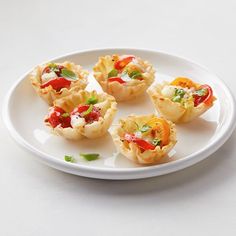 small appetizers are arranged on a white plate