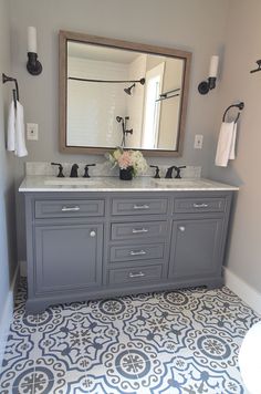 a bathroom with two sinks and a large mirror