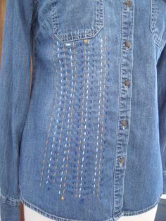 a woman's denim shirt with holes on it