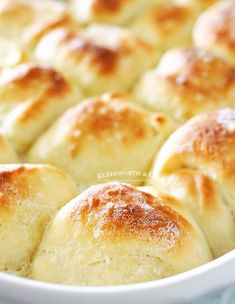 baked bread rolls in a white dish on a table