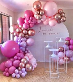 balloons are arranged in the shape of an arch for a 21st birthday party with pink, gold and white colors