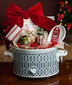 a christmas gift basket with candy, candies and other holiday treats in a bucket