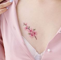 a woman's chest with pink flowers on it