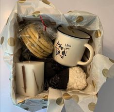 a white coffee cup filled with cookies and other items