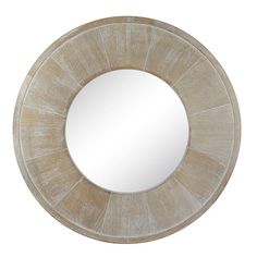 a round mirror on a white wall with a wooden frame and wood grain pattern around it