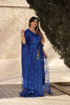 This beautiful royal blue Kurdish dress is designed to capture attention with its shimmering sequins and flowing silhouette, perfect for special occasions like weddings, cultural events, or formal gatherings. The traditional design is enriched with modern touches, offering a blend of elegance and cultural pride. The lightweight chiffon fabric allows for comfort, while the intricate hand-sewn sequins create a dazzling effect that is sure to stand out. The gown's long, draped sleeves enhance its g Kurdish Dress, Draped Sleeves, Cultural Festival, Cultural Celebration, Drape Sleeves, Chiffon Material, Cultural Events, Jewelry Show, Chiffon Fabric