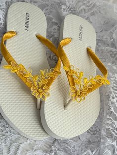 These beautiful white bridal flip flops are wrapped with a yellow satin ribbon, and adorned with a yellow beaded Bridal lace with pearls and sequins. All flip flops are handmade to order and the production time is 5-7 business days and then please allow additional time. Amazing for beach, weddings, flower girl or a fancy event, you choose! Please choose your size from the drop box. Pictured flip flops is a OLD NAVY brand. Please choose your flip flops size following the chart below to make sure Spring Wedding Beaded Sandals, White Beaded Sandals For Wedding, White Beaded Wedding Sandals, Gold Sandals For Summer Beach Wedding, Gold Sandals For Summer Wedding, Gold Wedding Sandals For Summer, White Summer Flip Flops As Gift, White Flip Flops As Summer Gift, Elegant Gold Flip Flops For The Beach