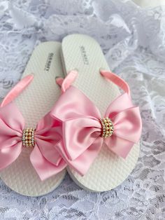 These beautiful flip flops are wrapped in pink satin ribbon, and adorned with a satin ribbon bow and accent with rhinestone button. Ribbon color is pink  if you are needing other colors of ribbon or decoration please contact me and will be happy to accommodate you! Sizes are for kids and adults. All flip flops are handmade to order and the production time 1 to 2 weeks and then please allow additional time for shipping. Amazing for beach, weddings, flower girl or a fancy event, you choose! Please Summer Satin Sandals With Satin Bow, Satin Bow Sandals For Summer, Summer Satin Sandals With Bow, Pink Bow Sandals For The Beach, Pink Beach Sandals With Bow, Adjustable Pink Sandals For Wedding, Summer Wedding Sandals With Satin Bow, Pink Wedding Sandals With Bow, Elegant Pink Adjustable Sandals