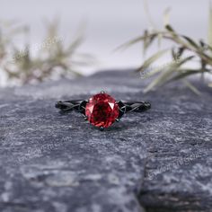 a red ring sitting on top of a rock