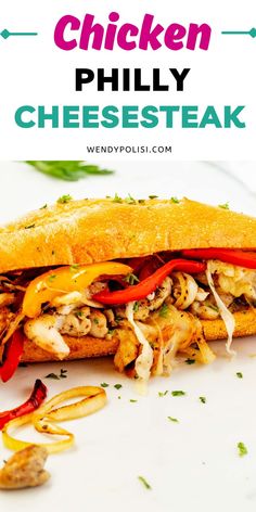 the chicken phily cheesesteak sandwich is cut in half on a white plate