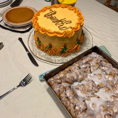 a table topped with two cakes covered in frosting