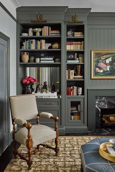 a living room filled with lots of furniture and bookshelves next to a fire place