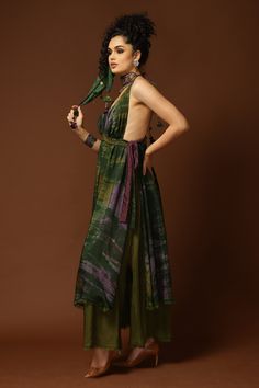 Green, olive green maxi dress with tie and dye print, layered hem and tie up detail on the sides.
Component: 1
Pattern: Print
Type Of Work: Tie and Dye
Neckline: V neck
Sleeve Type: Sleeveless
Fabric: Cotton Silk
Color: Green
Other Details: 
Side slits
Tie up shoulder straps
Note: Choker, polti bag and head scarf worn by the model is not for sale
Occasion: Resort - Aza Fashions Festive Green Silk Maxi Dress, Green Maxi Length Dress With Tie Back, Festive Silk Dress With Back Tassel Tie-up, Summer Floor-length Dress With Back Tassel Tie-up, Polti Bag, Tie And Dye Dress, Dye Dress, Green Maxi, Green Tie