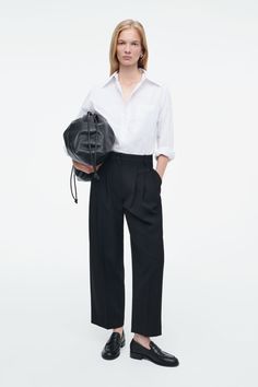 These pants are designed in a barrel-leg shape that will add a directional touch to the daily wardrobe. Offered in timeless black, they are cut from wool-blend twill with pleats that define the curved legs and cropped hems that frame your shoes. They're finished with slanted pockets, belt loops and a welt pocket on the back.  Regular fitButton and zip closureA better alternative to conventional polyester, recycled polyester is made from pre‐ and post‐consumer waste  Shell: 49% Recycled polyester, 44% RWS Wool, 5% Polyester, 2% Elastane. Pocket Lining: 100% Cotton. Excluding trims / Dry clean Inside leg length of size 6 is 25.19" / Model wears a size 6 Barrel Pants, Mens Straw Hats, Mens Cardigan Sweater, Accessories Bags Shoes, Denim Sweater, Black Trousers, Your Shoes, Short Shirts, New Arrival Dress