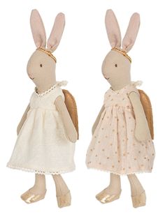 two stuffed rabbits dressed in white dresses