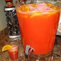 there is an orange drink in the glass on the counter