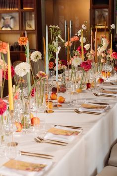 a long table is set up with flowers and candles for an elegant dinner or party