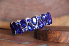 "Beautiful bracelet with rhinestone crystals, great statement piece! Pageant, prom, or bridal! Size: .75\" wide Style: stretch bracelet color: royal blue crystals Looking for matching earrings? Browse through our listings or send us a message! :) https://www.etsy.com/listing/510142252/blue-large-crystal-earrings-royal-blue?ref=shop_home_feat_1 https://www.etsy.com/listing/551767759/statement-blue-crystal-necklace-set?ref=shop_home_active_45 https://www.etsy.com/listing/481059043/extra-long-blue- Royal Blue Bracelet, Prom Bracelet, Valentines Bracelets, Blue Crystal Necklace, Large Crystal, Bridal Bracelet, Rose Gold Bracelet, Rhinestone Bracelet, Large Crystals