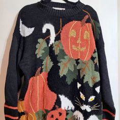 an ugly sweater with cats and pumpkins on it