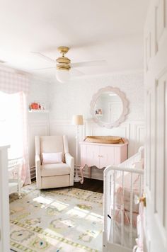 a baby's room with a crib, rocking chair and dresser in it