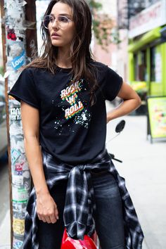 Put another dime in the jukebox baby THE PERFECT FITTING TEE - a slight high-low cut flatters every gorgeousshape. Bra friendly too!Color: black with multi color distressed print 100% slub cotton | Pre-washed | Super soft | Dyed for the perfect vintage colorDetailed with distressed double raw edge seams and contrast seam stitching for a unique vintage look. Each garment is cut, sewn, dyed and printed in Los Angeles California.All raw materials are 100% proudly made in U.S.A. Sizing - Unsweetened Black Cotton T-shirt With Paint Splatter, Black Graphic Tee With Paint Splatter, Casual Black Top With Paint Splatter, Black Paint Splatter Cotton T-shirt, Black Cotton Top With Paint Splatter, Black Cotton Tops With Paint Splatter, Black Cotton Tops With Paint Splatter Detail, New York Fits, Rock Roll