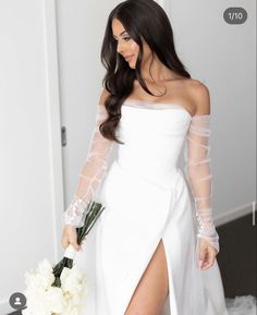 a woman in a white dress holding a bouquet