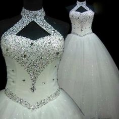 two white wedding dresses on display in front of a black background