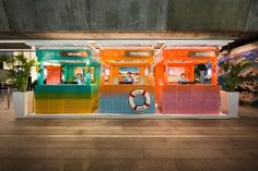 an empty parking garage with brightly colored booths