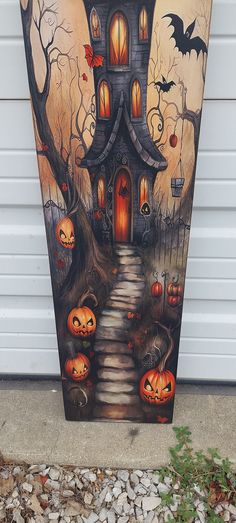 a painting of a house with pumpkins on it